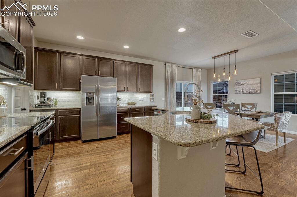 Image 14 of 50: View of the Island Kitchen and Dining Area.