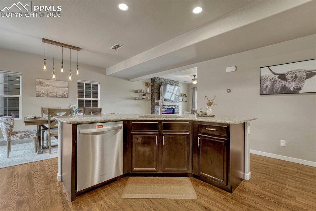 Image 15 of 50: The Kitchen overlooks the Dining Area and Living Room.