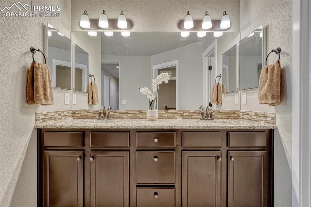 Image 32 of 50: Raised dual sink vanity in the Primary Bathroom.