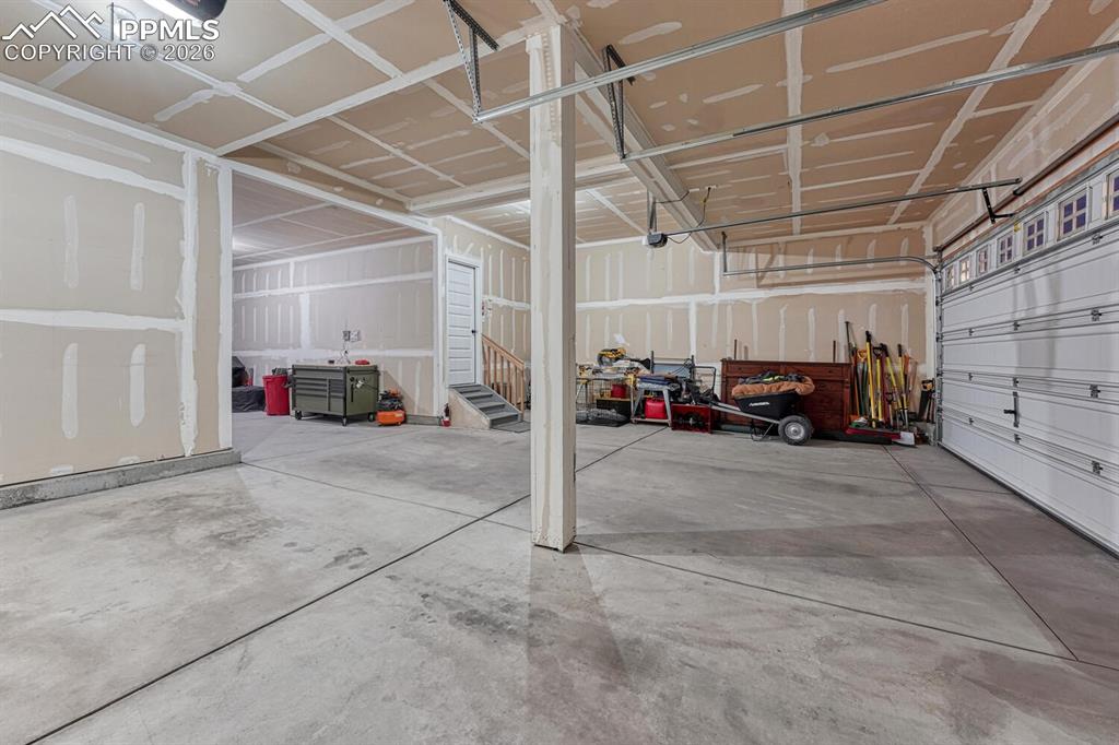 Image 44 of 50: 4-car attached garage with door opener.