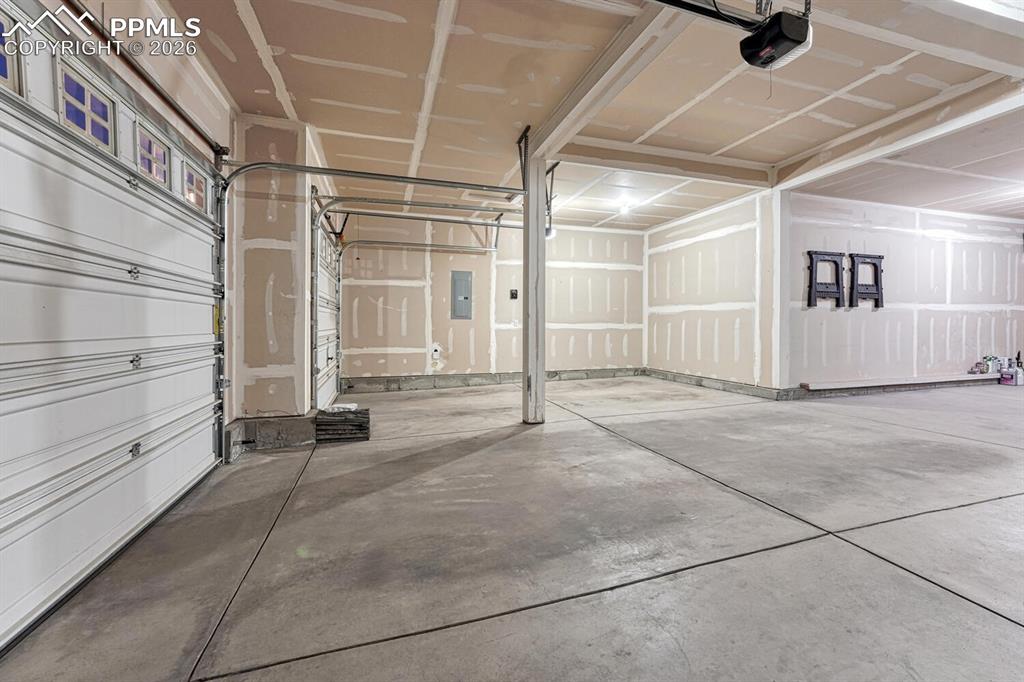 Image 45 of 50: Lots of room in the 4-car attached garage for cars, tools, and toys.