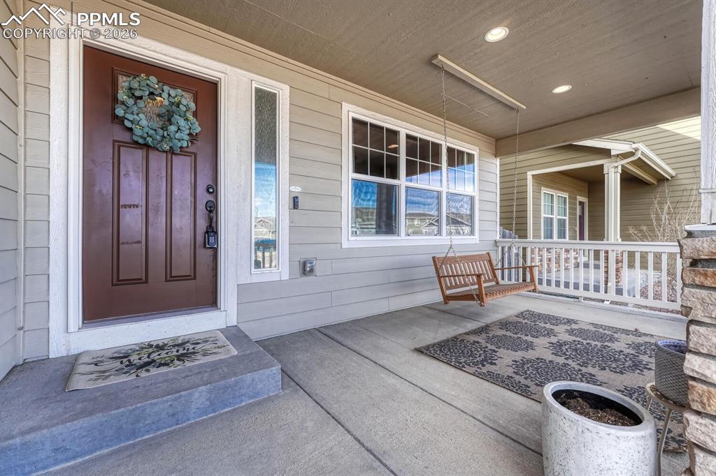 Image 5 of 50: Covered front porch to enjoy the Colorado sunshine.