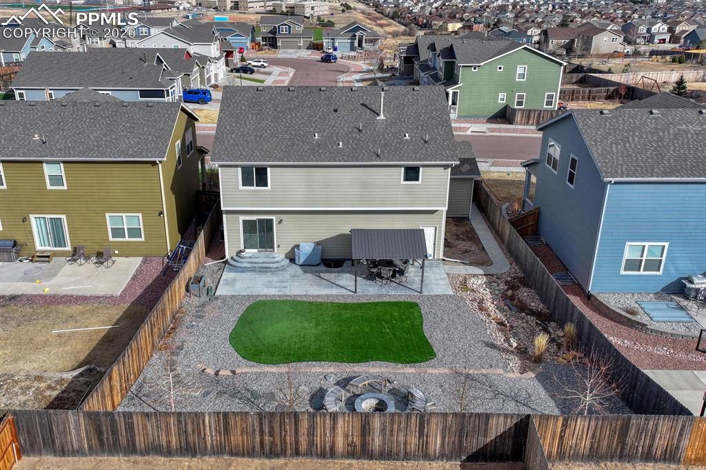 Image 50 of 50: Aerial rear view of home and fenced backyard.