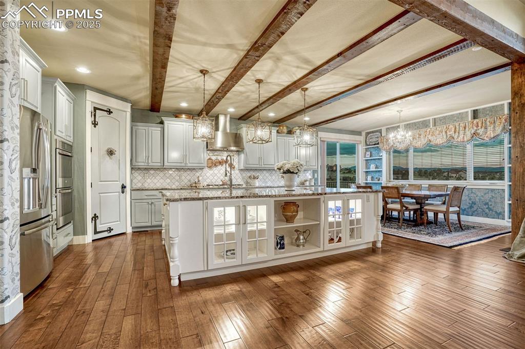 Image 15 of 45: Elegance from corner to corner. The kitchen features Dacor and Miele applia