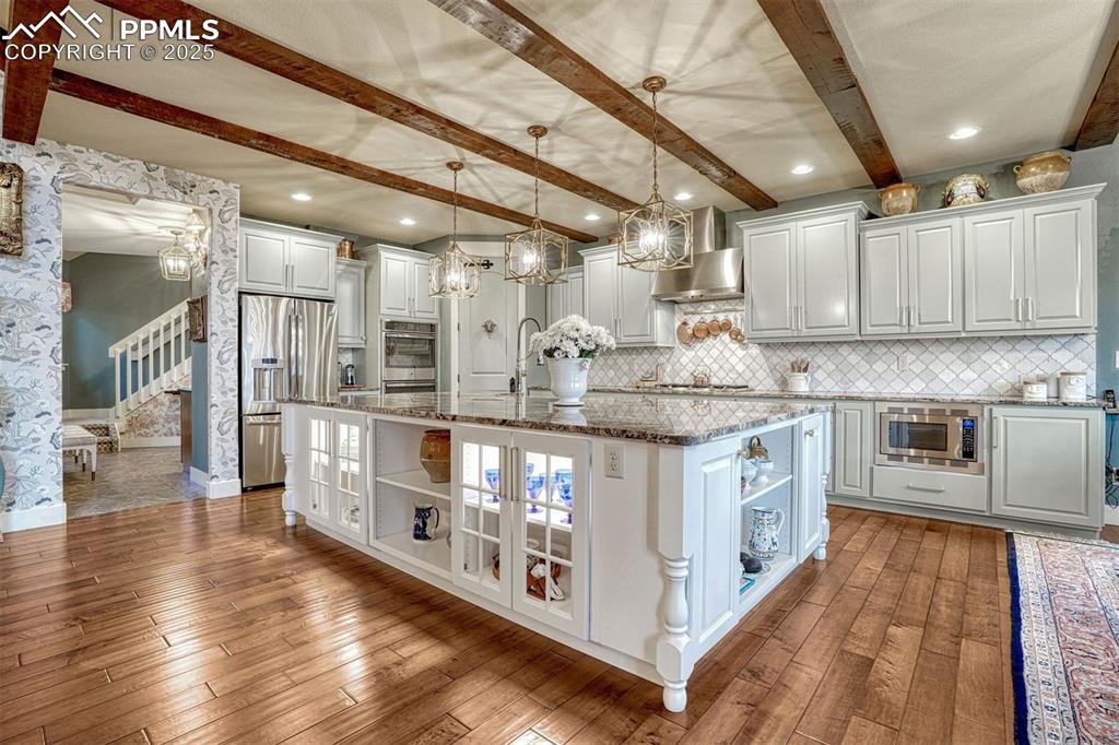 Image 16 of 45: The heart of the home is always the kitchen. With it’s calming hues and cur