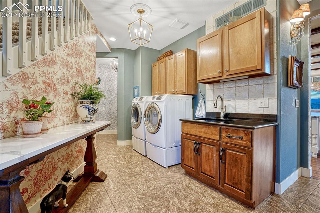 Image 22 of 45: The main level laundry room is both functional and inviting, with thoughtfu