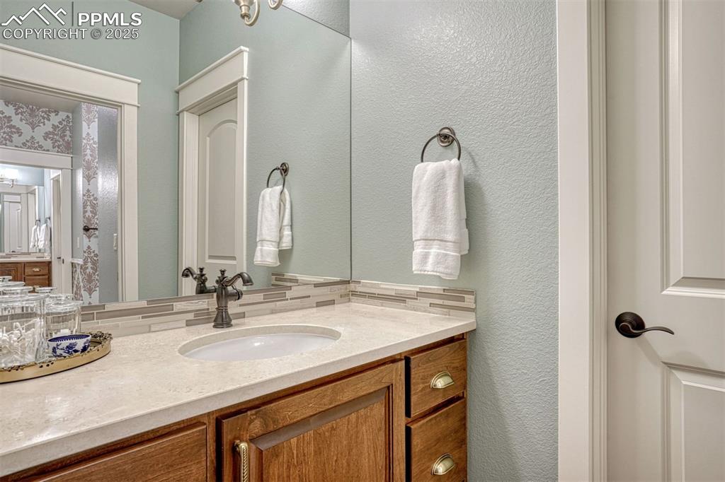 Image 35 of 45: Shared bath with double sinks and elegant hardware