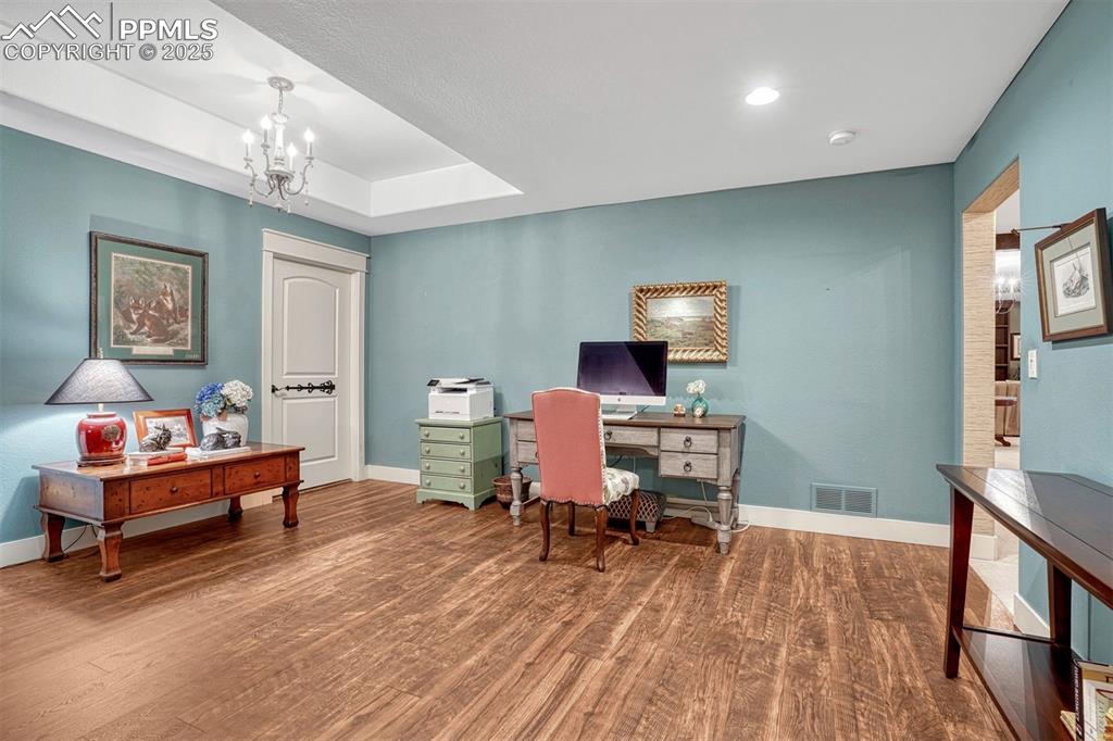 Image 38 of 45: This downstairs bedroom is currently being used as an office and library. W