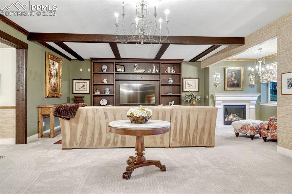 Image 7 of 45: Downstairs, the recreation room has old world charm in the beamed ceiling,