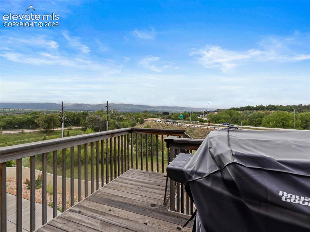 Image 14 of 45: Spacious outdoor deck featuring natural wood flooring and a sturdy wood rai