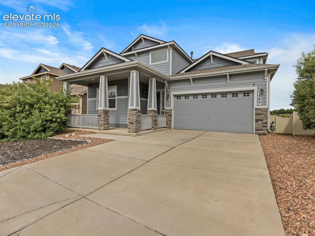 Image 2 of 45: Contemporary two-story residence featuring light gray siding and stone vene