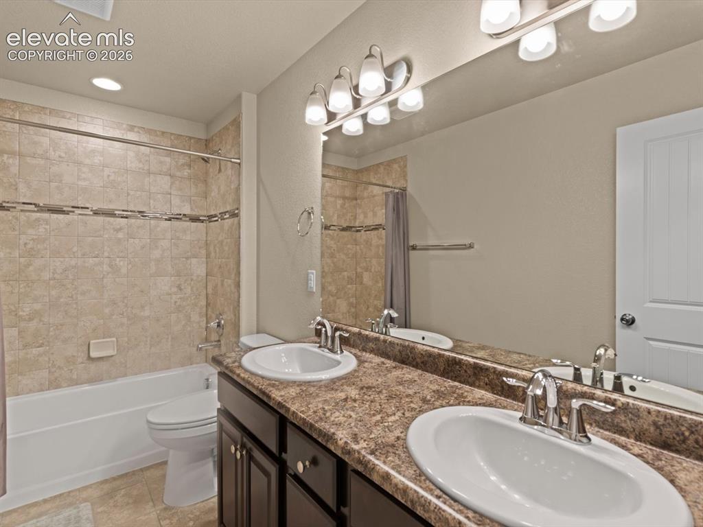 Image 30 of 45: Double vanity featuring oval undermount sinks and chrome fixtures