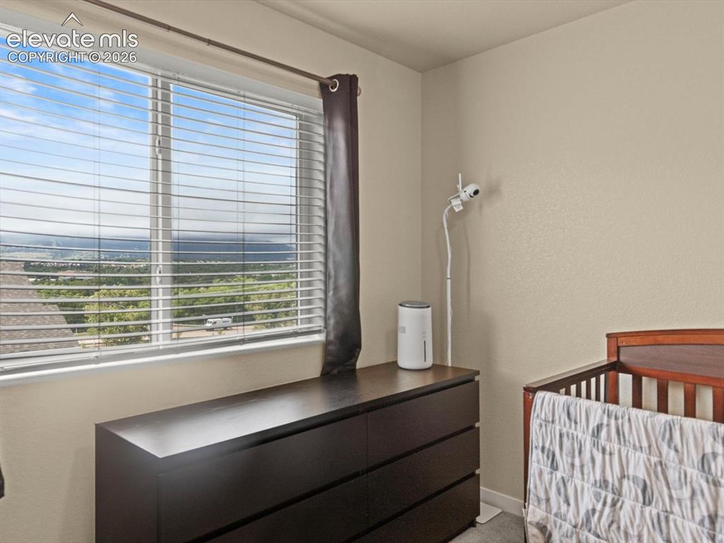 Image 34 of 45: Expansive window featuring horizontal blinds and a distant landscape