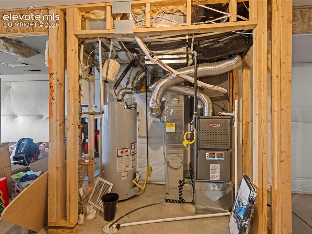 Image 40 of 45: Mechanical room featuring a water heater, furnace unit, and extensive ductw