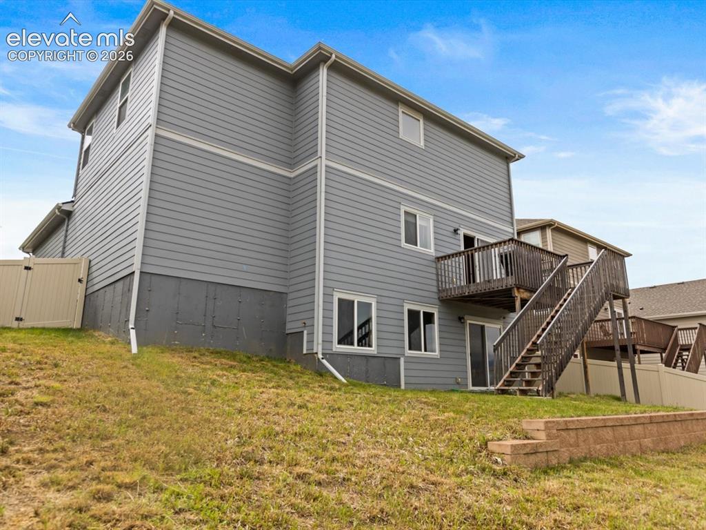 Image 42 of 45: Gray siding exterior featuring a multi-level deck and staircase