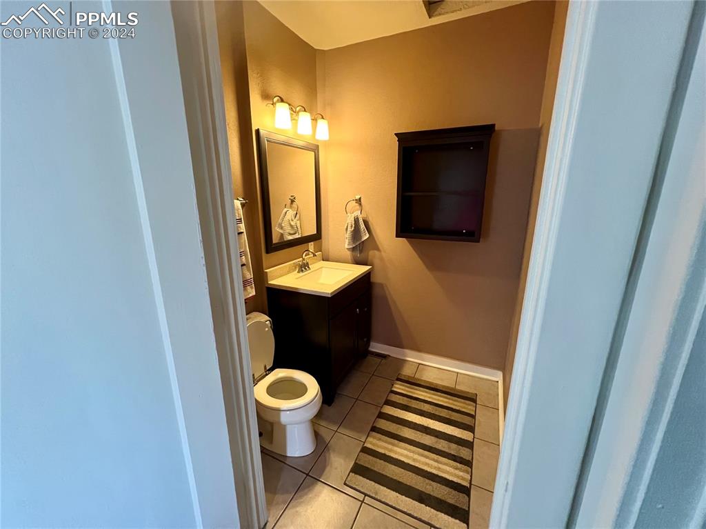 Image 10 of 18: Bathroom featuring toilet, tile floors, and vanity