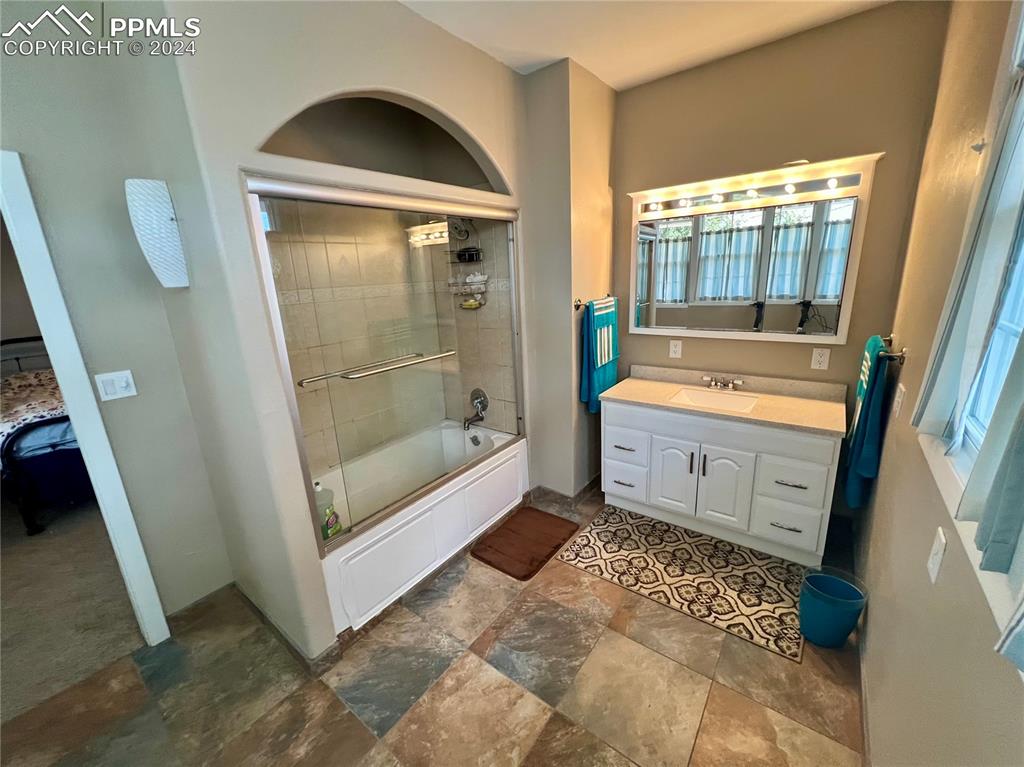 Image 13 of 18: Bathroom featuring plenty of natural light, shower / bath combination with