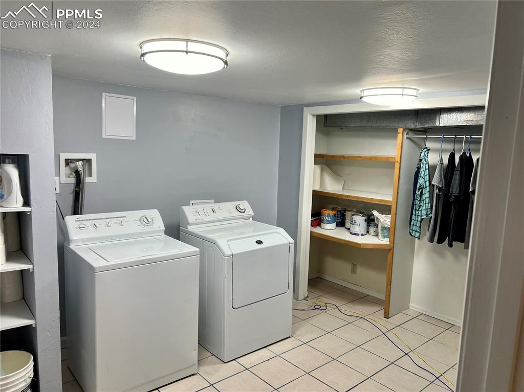 Image 18 of 18: Clothes washing area featuring washer hookup, washing machine and clothes d