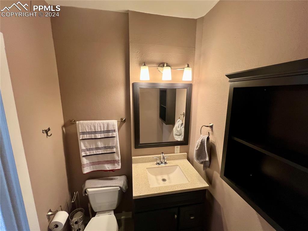 Image 9 of 18: Bathroom with toilet and vanity