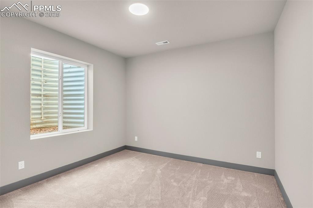 Image 10 of 50: Carpeted empty room featuring baseboards, visible vents, and a healthy amou