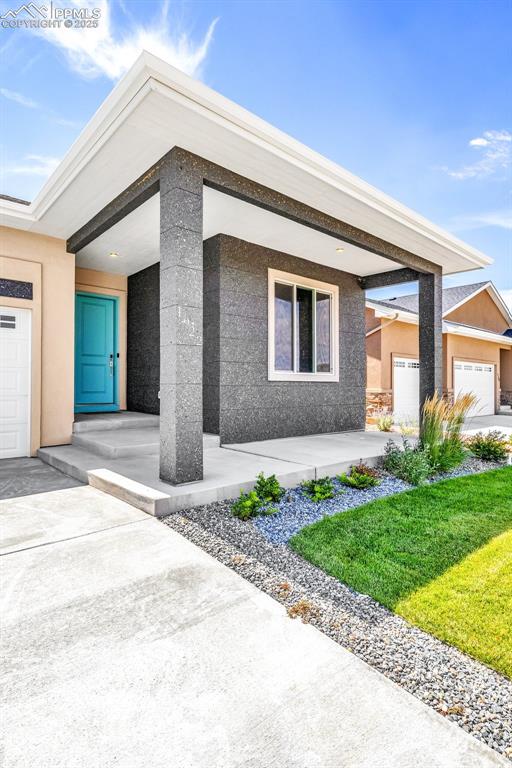 Image 2 of 50: View of front of house featuring concrete driveway, an attached garage, and