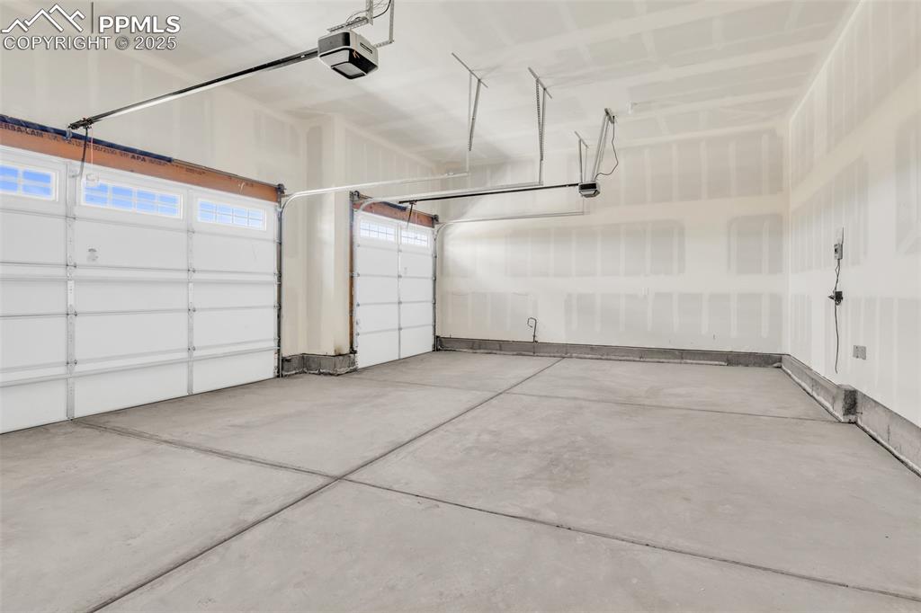 Image 33 of 50: Garage with a garage door opener