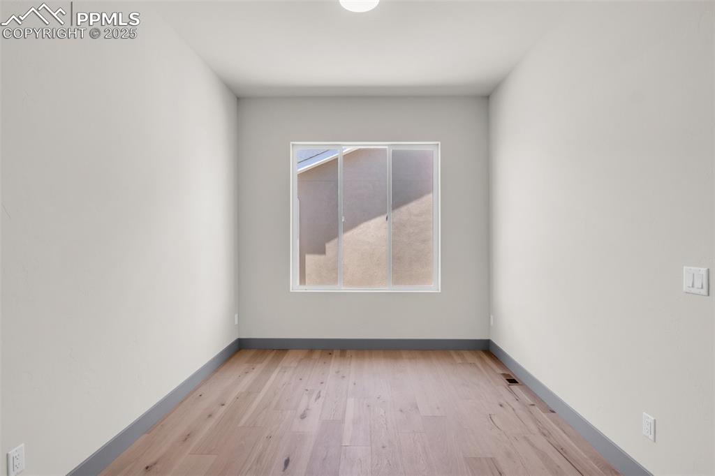Image 44 of 50: Empty room featuring light wood-type flooring and baseboards