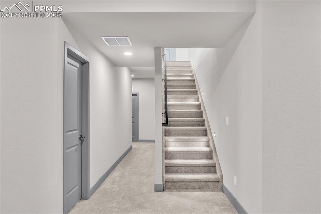 Image 7 of 50: Stairway featuring recessed lighting, baseboards, visible vents, and carpet