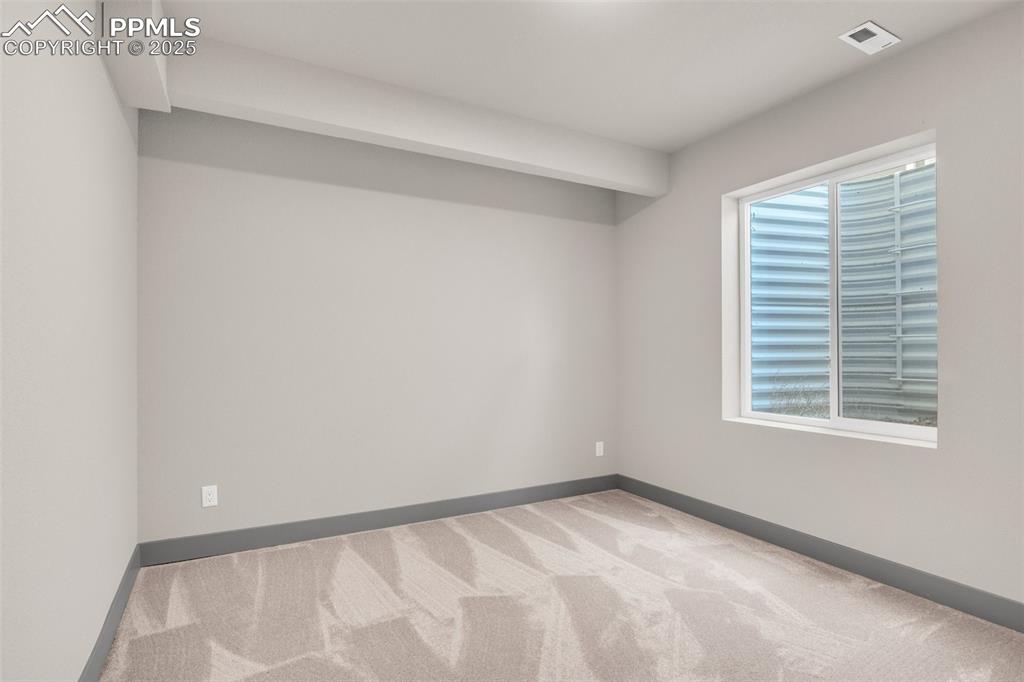 Image 9 of 50: Carpeted spare room featuring plenty of natural light, baseboards, and visi