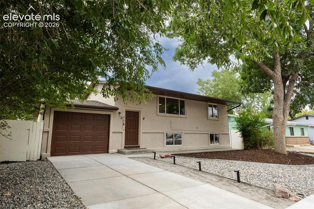 Image 1 of 32: Stucco exterior, attached one-car garage, concrete driveway, front entry do