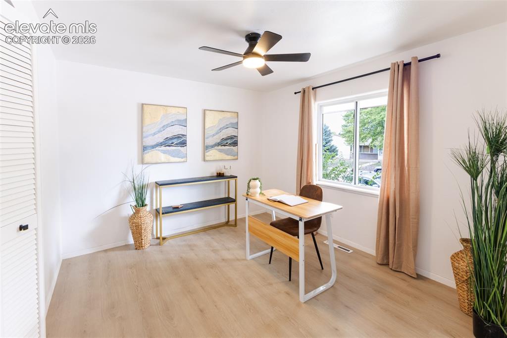 Image 13 of 32: Upstairs office with large window and storage closet