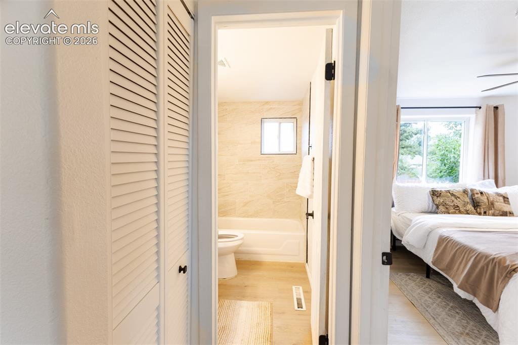 Image 17 of 32: Hall between upstairs bedroom and bathroom, linen closet.