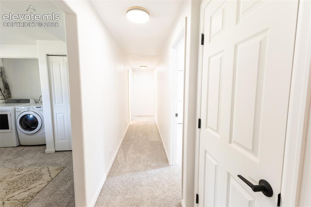 Image 21 of 32: Hallway with carpeting and flush mount lighting