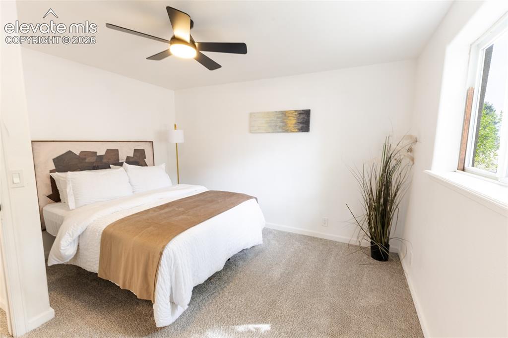 Image 23 of 32: Recessed window, white walls, flush-mounted ceiling fan, light-toned carpet