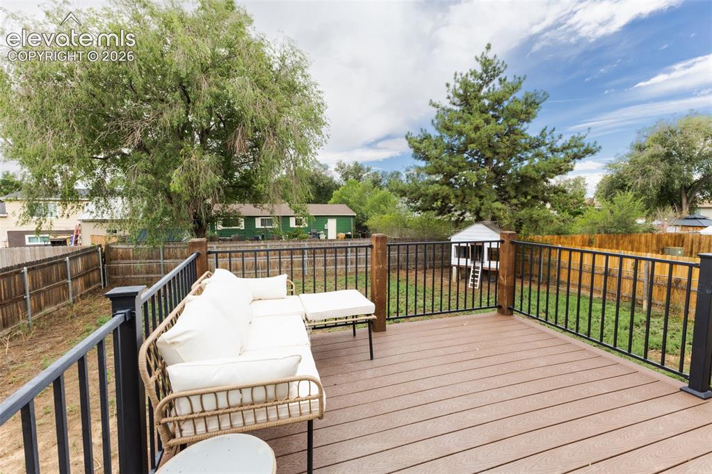 Image 29 of 32: Expansive outdoor deck featuring wood-finish flooring, dark-toned railings,