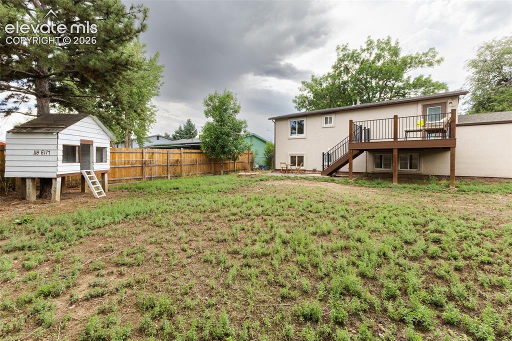 Image 32 of 32: Spacious backyard featuring treehouse.