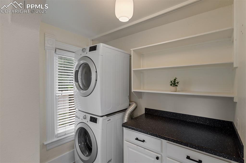 Image 11 of 32: The laundry is located on the main level with a folding area and built in s