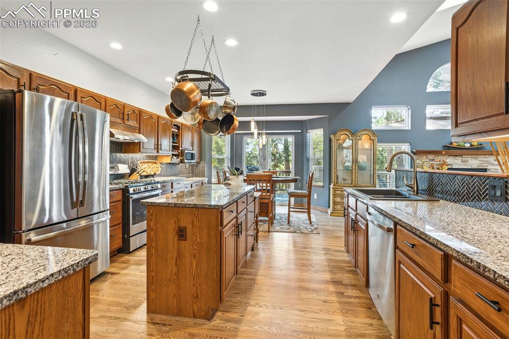 Image 13 of 50: Chefs will delight w/all the granite countertops and island prep space.