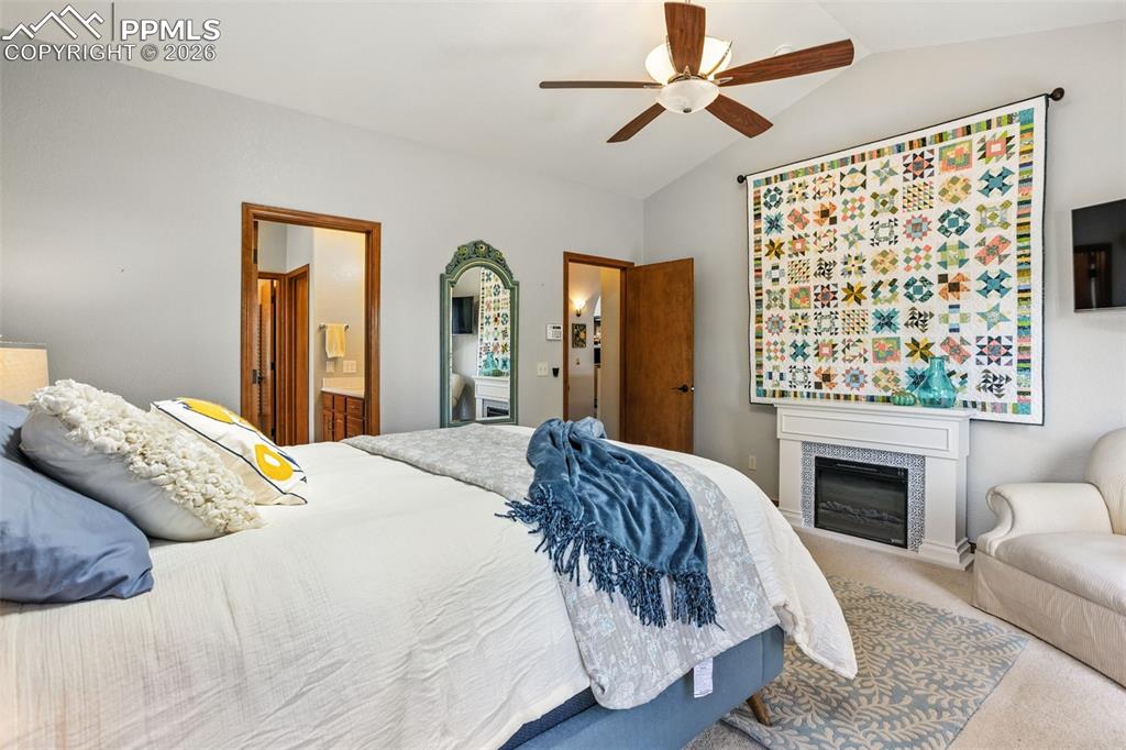 Image 18 of 50: Addl features include a vaulted ceiling and sky light.  Electric fireplace 