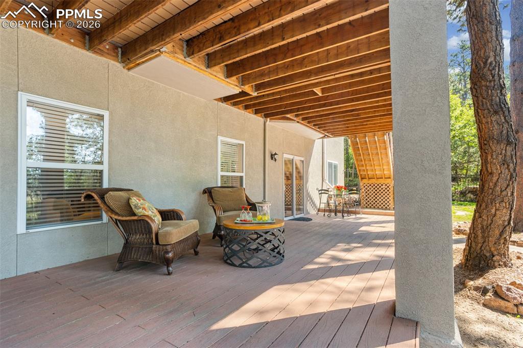 Image 42 of 50: Covered composite deck on lower level would be a great place for a hot tub!