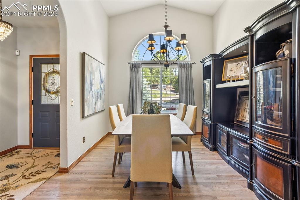 Image 5 of 50: Formal dining room w/vaulted ceiling & arched window add elegance
