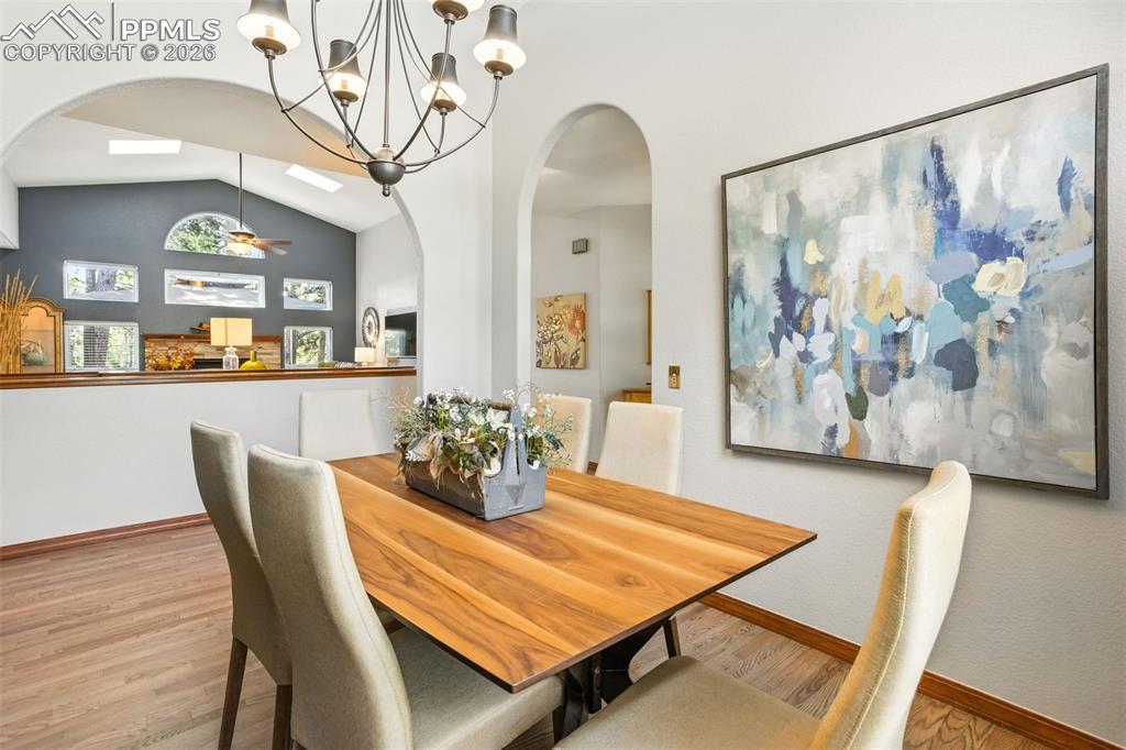 Image 6 of 50: Arched doorways carry thru the dining & living room spaces