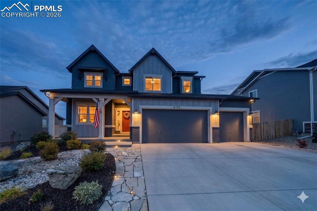 Image 1 of 47: Two-story exterior with a covered porch, attached two-car garage, and a con