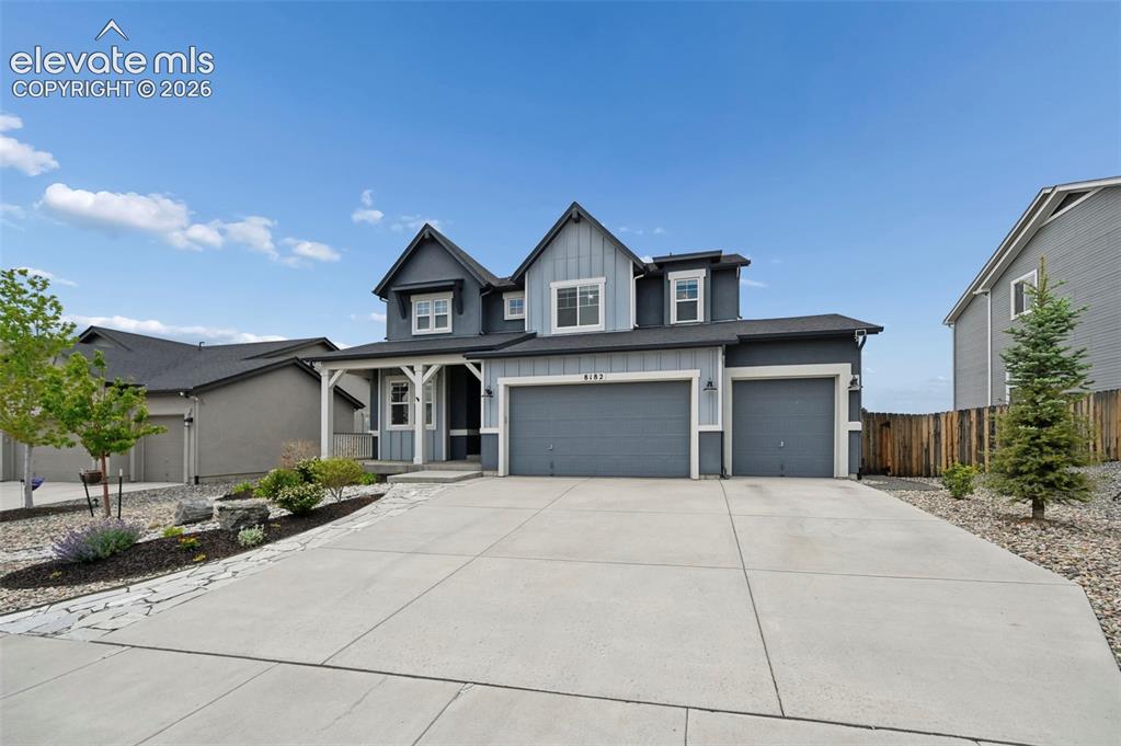 Image 2 of 47: Contemporary exterior featuring board and batten siding, a covered porch, a