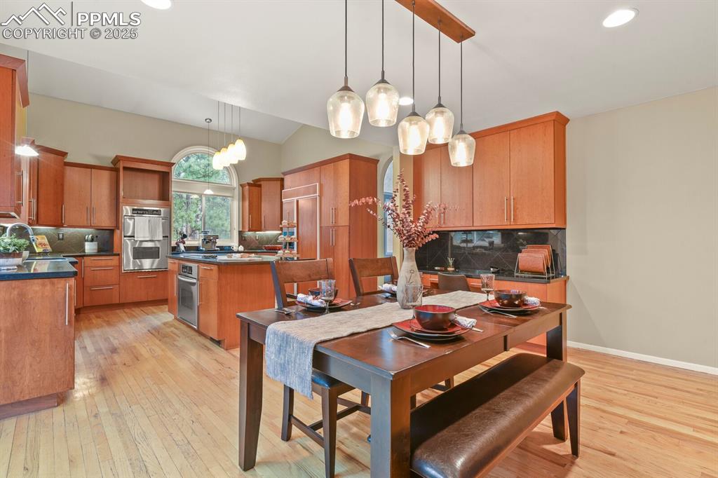 Image 10 of 50: Dining room with light wood-type flooring, recessed lighting, and lofted ce