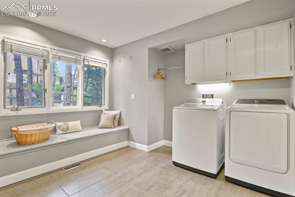 Image 18 of 50: Laundry room with cabinet space, washer and clothes dryer, and recessed lig