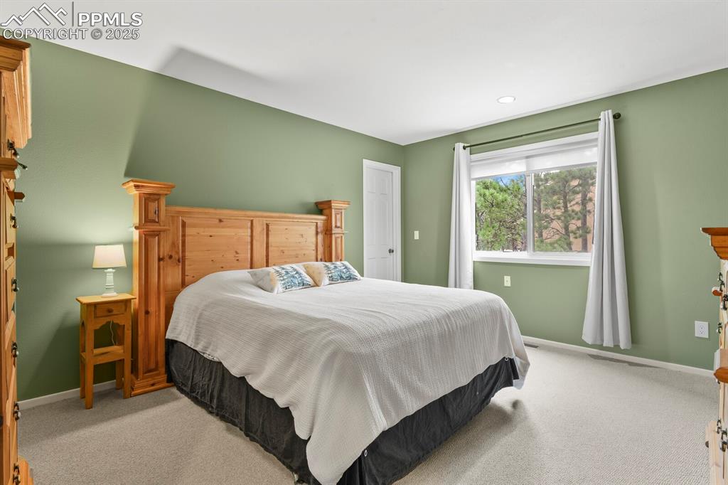 Image 28 of 50: Bedroom featuring light colored carpet and recessed lighting