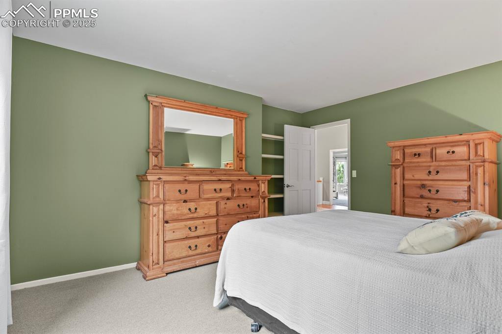 Image 29 of 50: Carpeted bedroom featuring baseboards