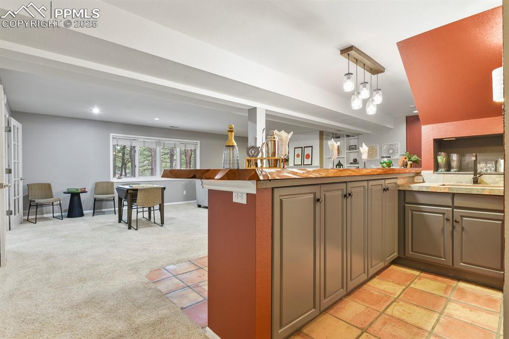 Image 35 of 50: Kitchen featuring a peninsula, recessed lighting, light countertops, hangin