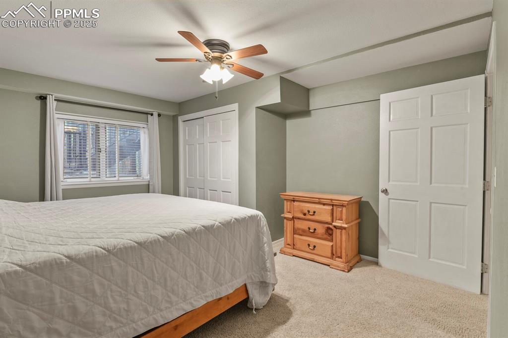 Image 39 of 50: Bedroom with carpet, a ceiling fan, and a closet